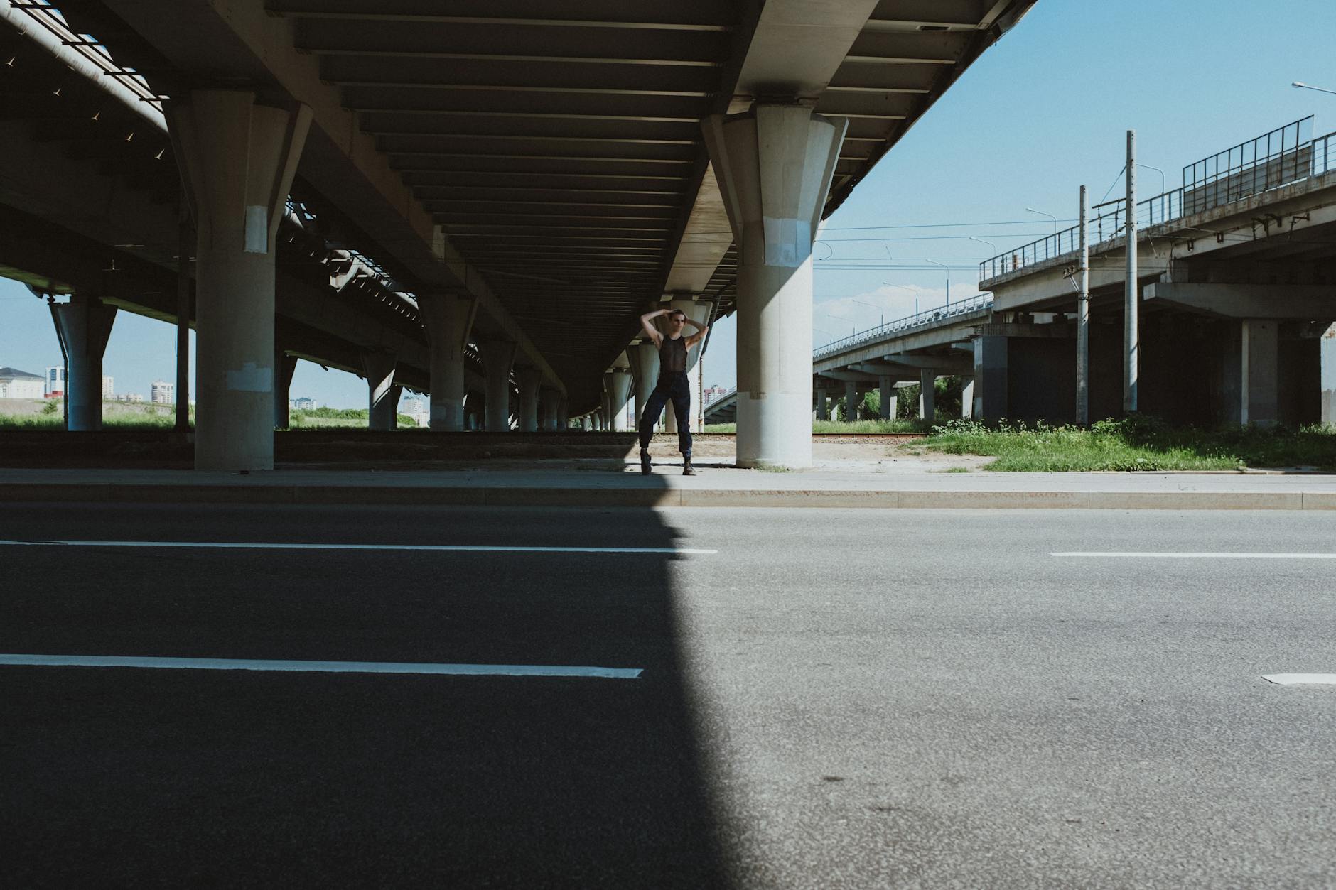 Tancerka pozująca pod miejskim wiaduktem autostradowym