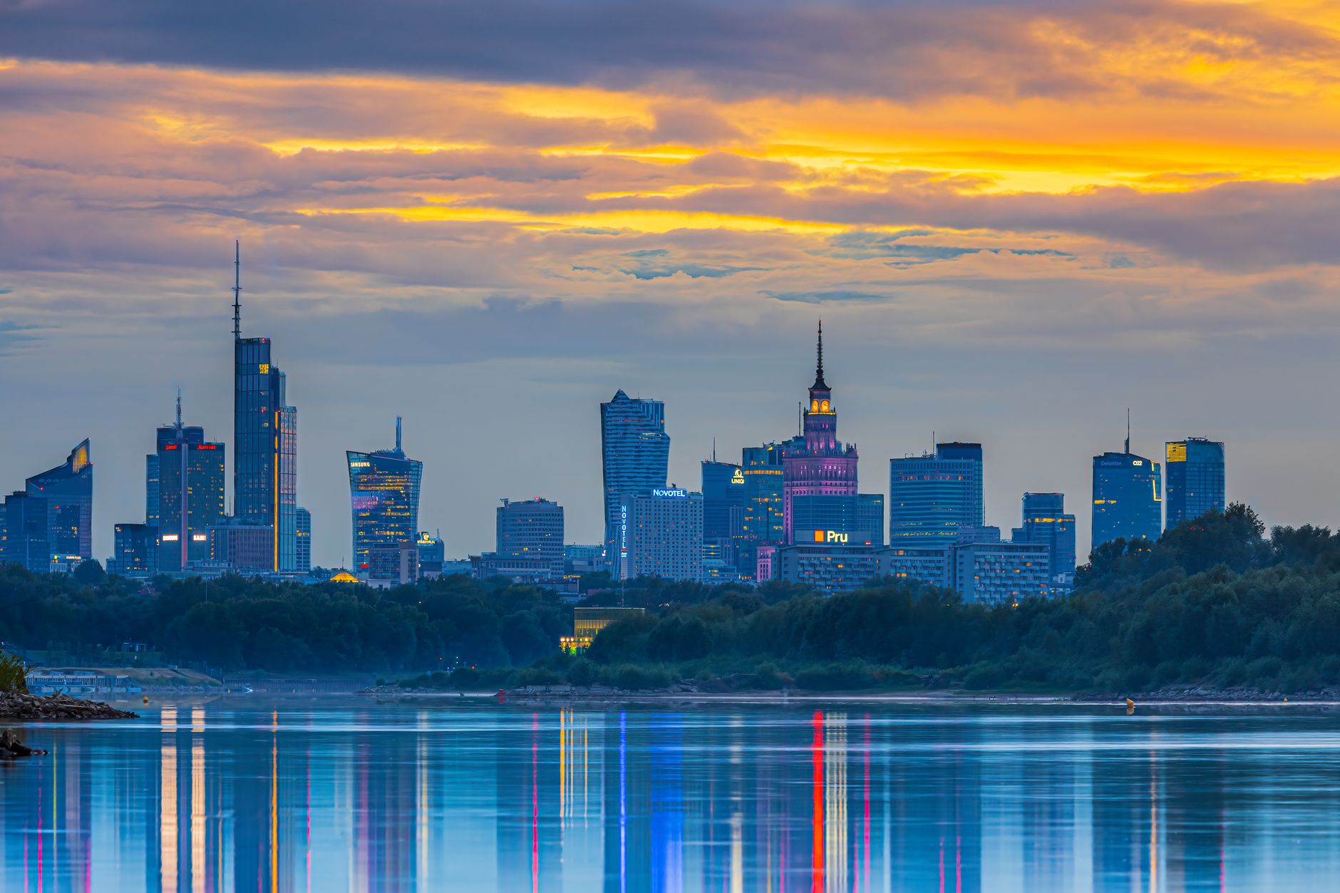 Panorama Warszawy o zachodzie słońca odbijająca się w Wiśle
